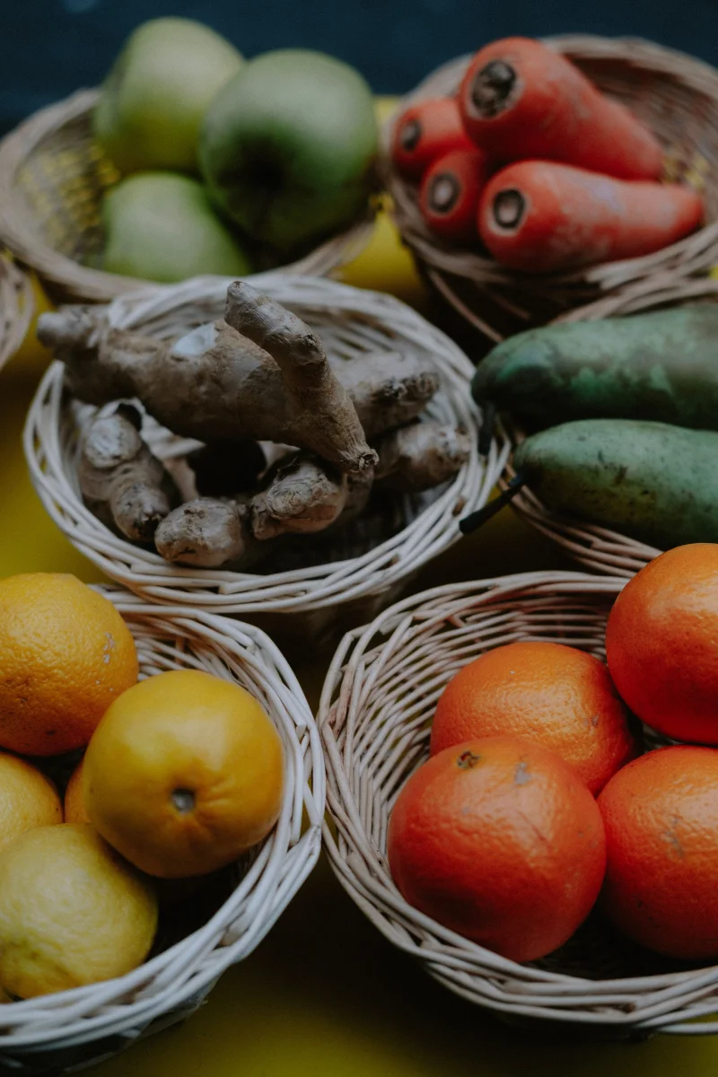 A vibrant collection of fruits and vegetables displayed in wicker baskets.