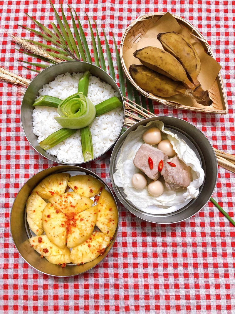 A vibrant display of traditional Vietnamese food on checkered tablecloth.