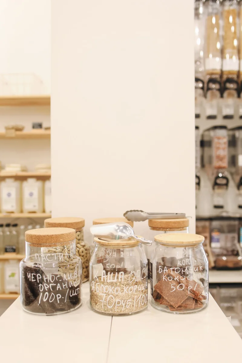 Explore a zero-waste store featuring diverse snacks in glass jars, promoting sustainable shopping.