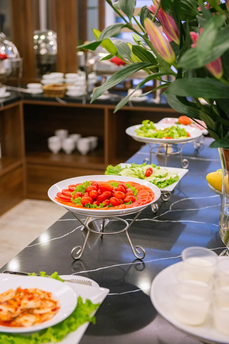 Buffet table with fresh salads and elegant presentation in a restaurant setting in Hanoi, Vietnam.