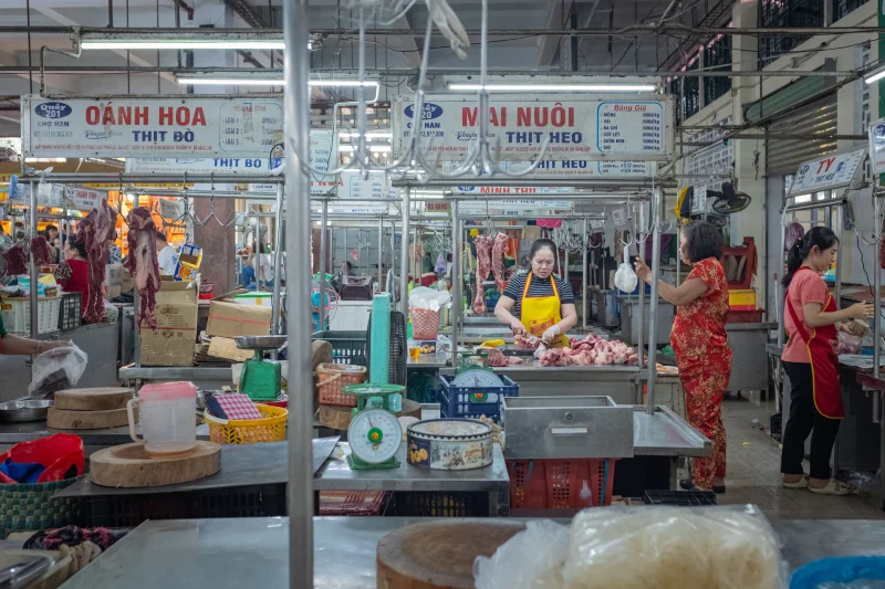 Vibrant scene in Da Nang market showcasing local vendors and fresh meats in Vietnam.