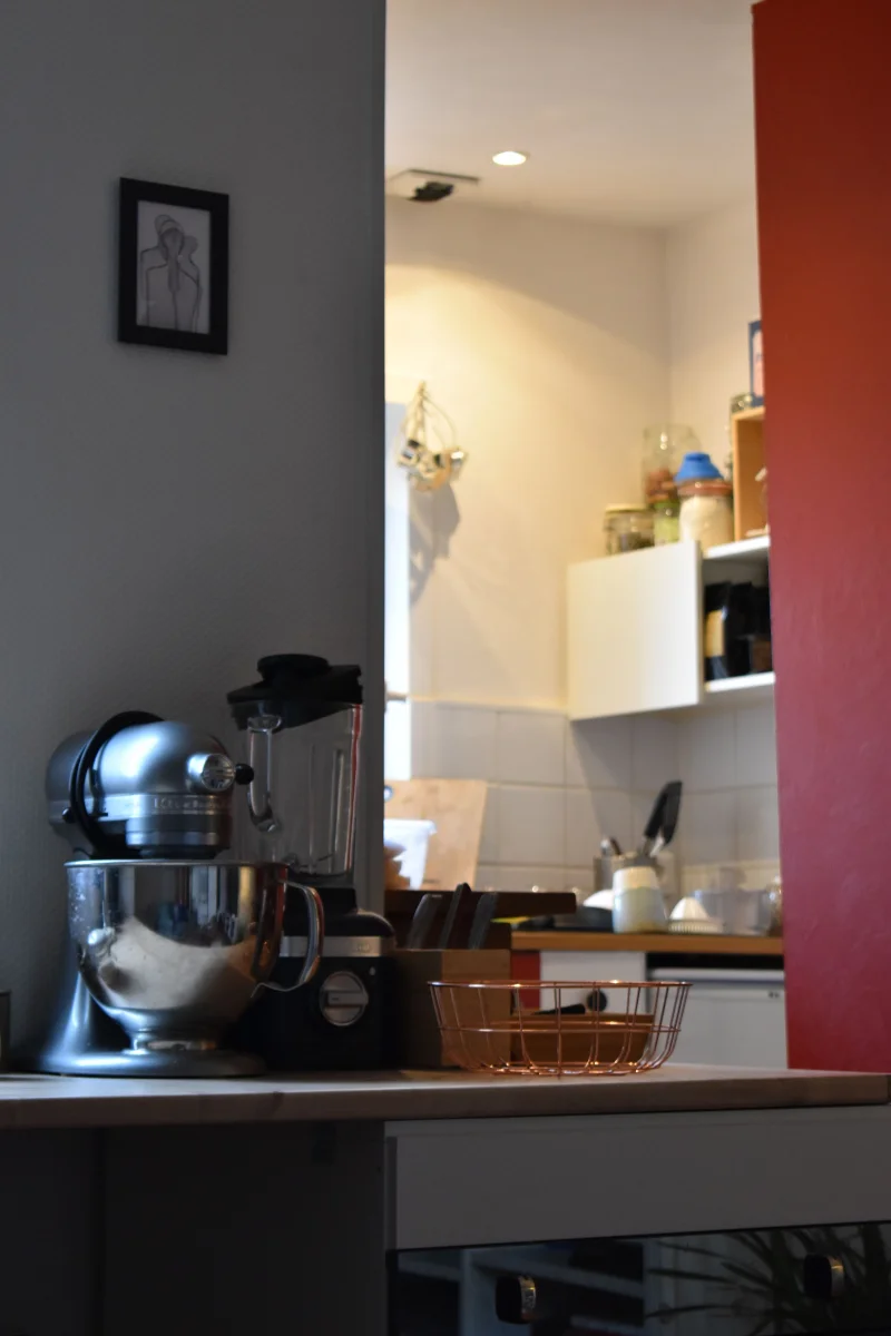 A cozy kitchen setup featuring a mixer and blender on a countertop with warm lighting.